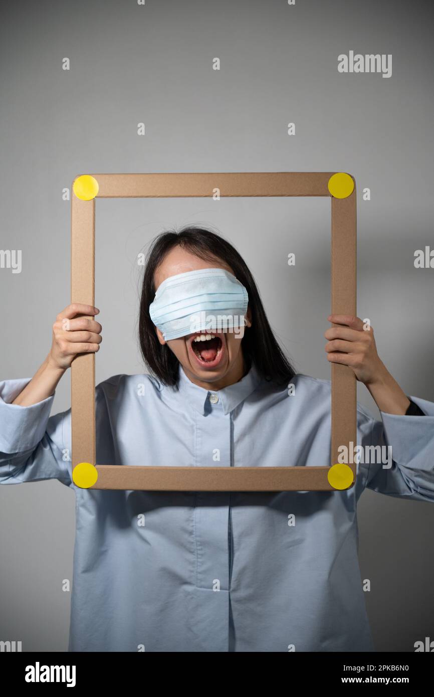 Masked and angry asian young woman Stock Photo - Alamy