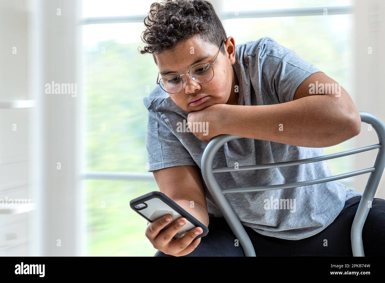 Young mixed race woman texting. Stock Photo