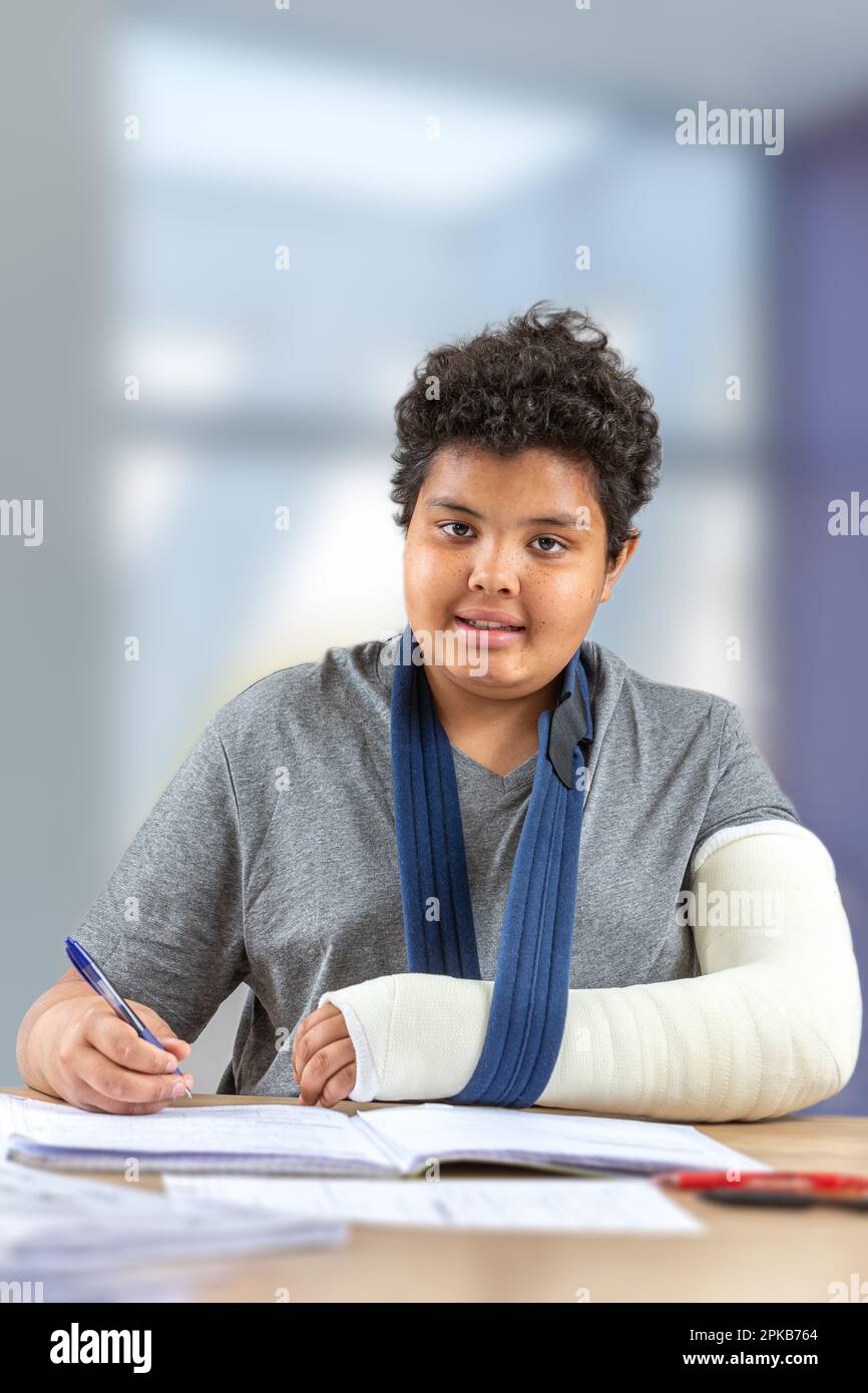 Young boy in tran doing his homework. Stock Photo