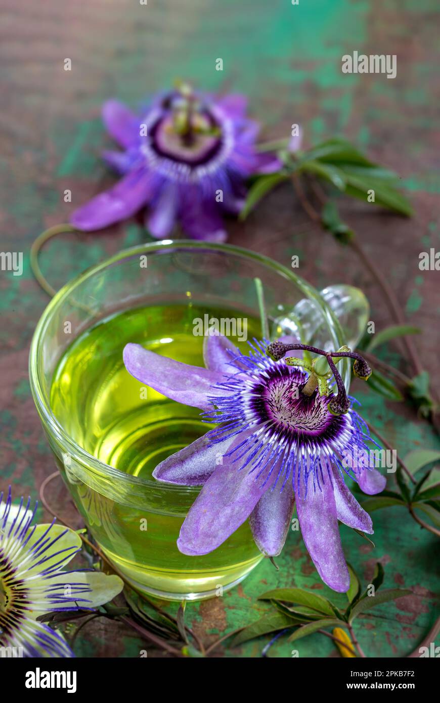 Passionflower herbal tea (Passiflora caerulea) in a glass cup on old board. Stock Photo