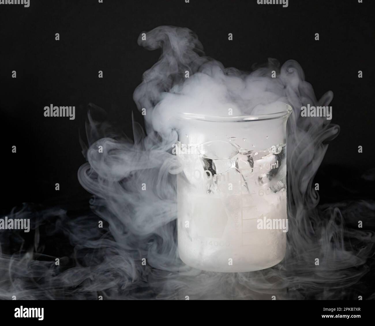 Dry ice sublimating in a glass beaker Stock Photo