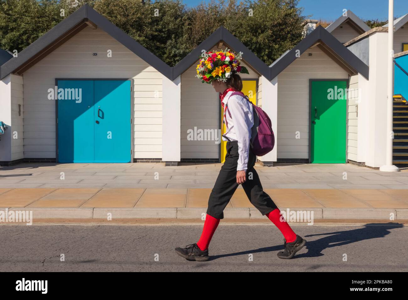 England, Dorset, Isle of Purbeck, Swanage, Swanage Folk Festival, Morris Dancer and Daughter in front of Colourful Beach Huts Stock Photo