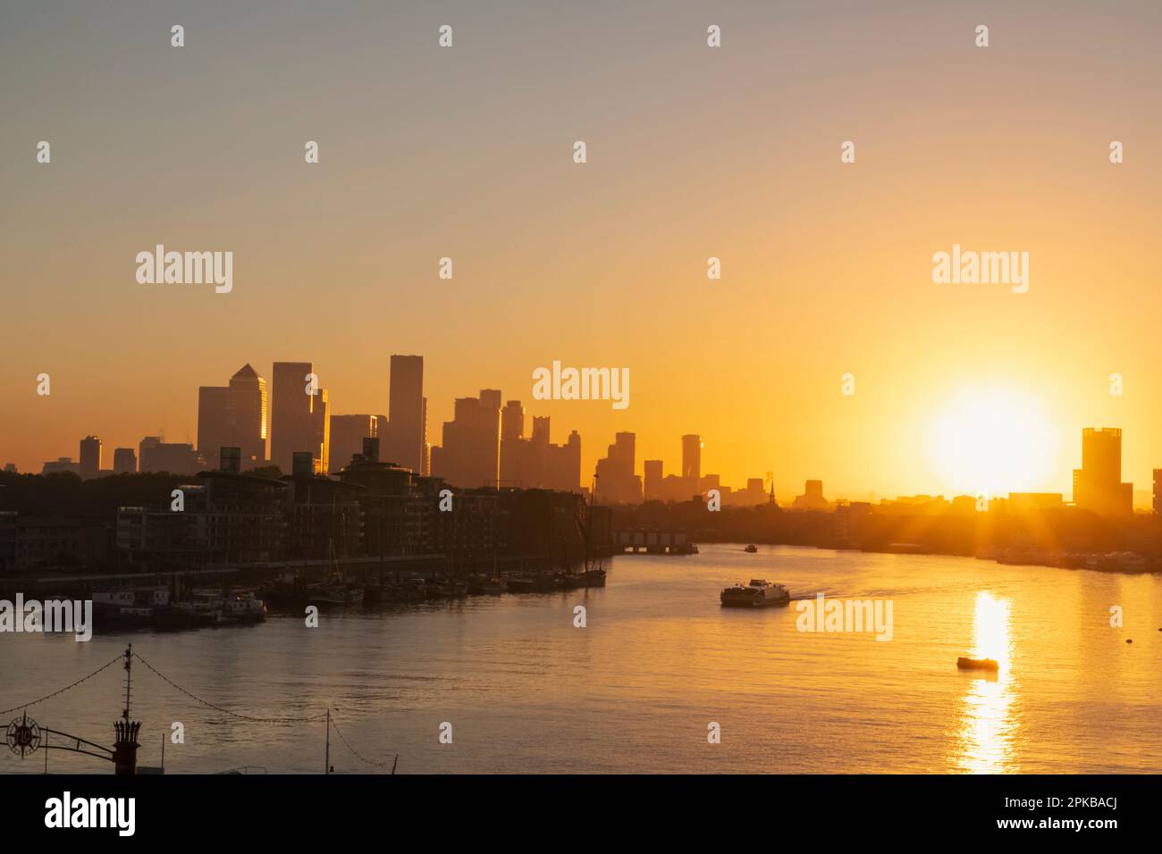 England, London, Sunrise over Canary Wharf Skyline and River Thames ...