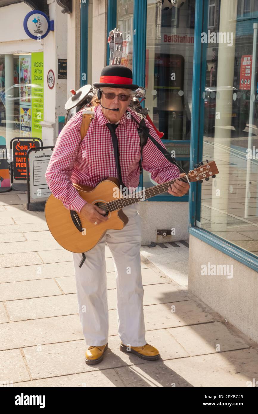 England, Dorset, Isle of Purbeck, Swanage, Swanage Annual Folk Festival, Elderly One Man Band Playing Guitar and Singing Stock Photo
