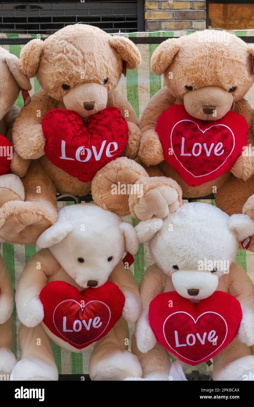 England, London, Spitalfields, Petticoat Lane Market, Display of Teddybears Holding Love Hearts Stock Photo