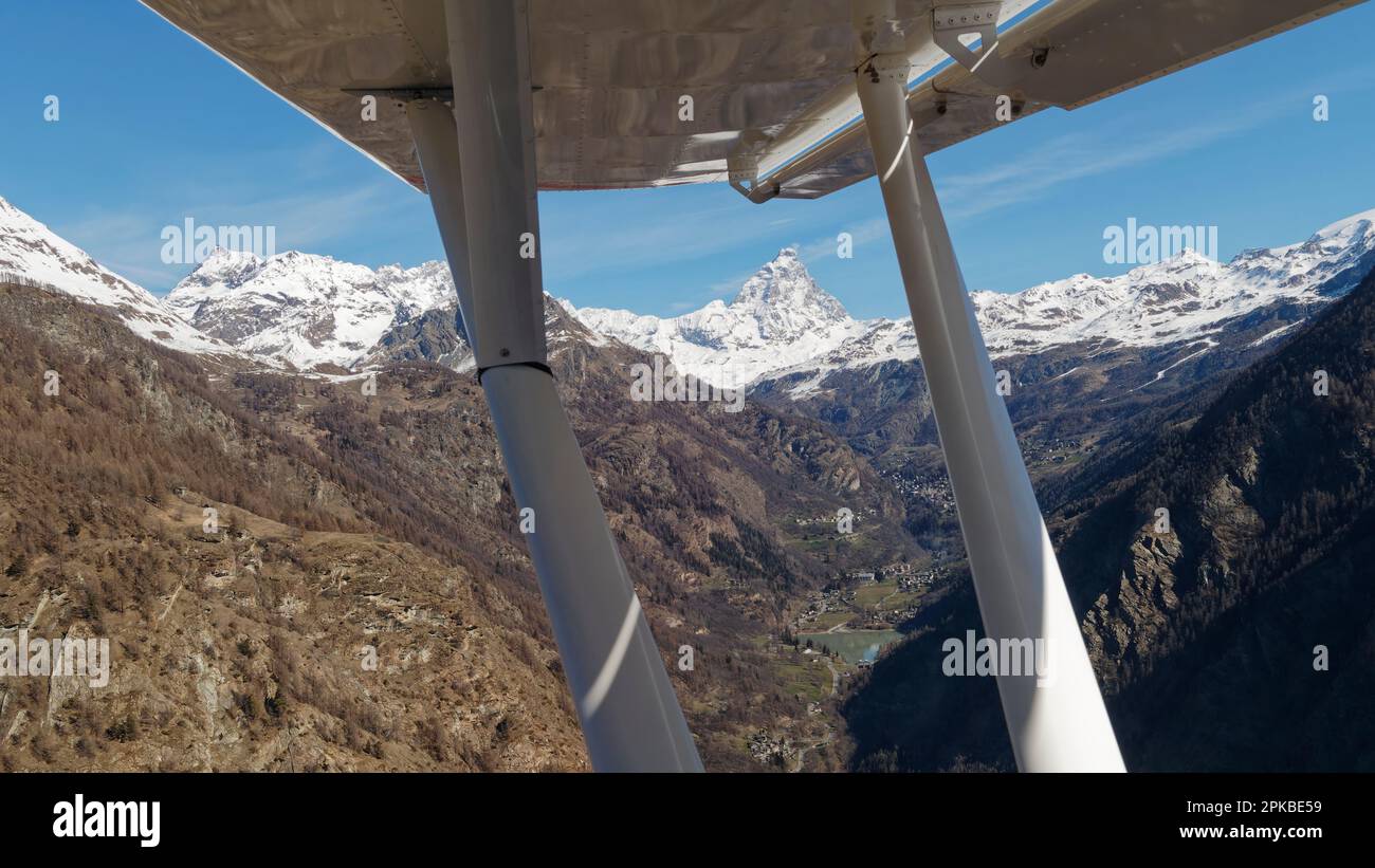 Panaoramic view from a light aircraft flight towards the Matterhorn aka Cervino mountain, with the wing in the foreground, Aosta Valley Italy Stock Photo