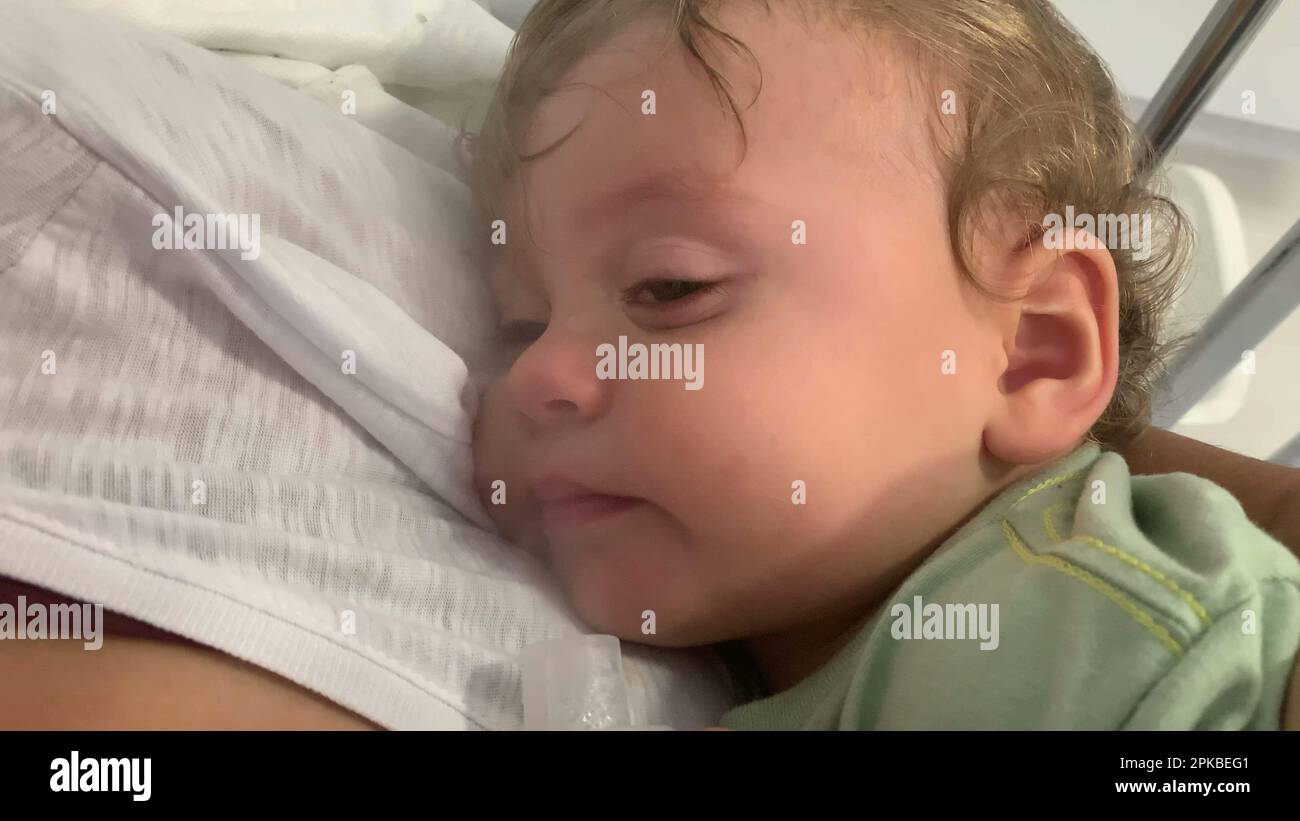 Sick baby coughing with inhaler. toddler coughs with respiratory