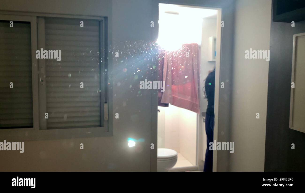 Particles in the air sun flare shining through window at apartment ...