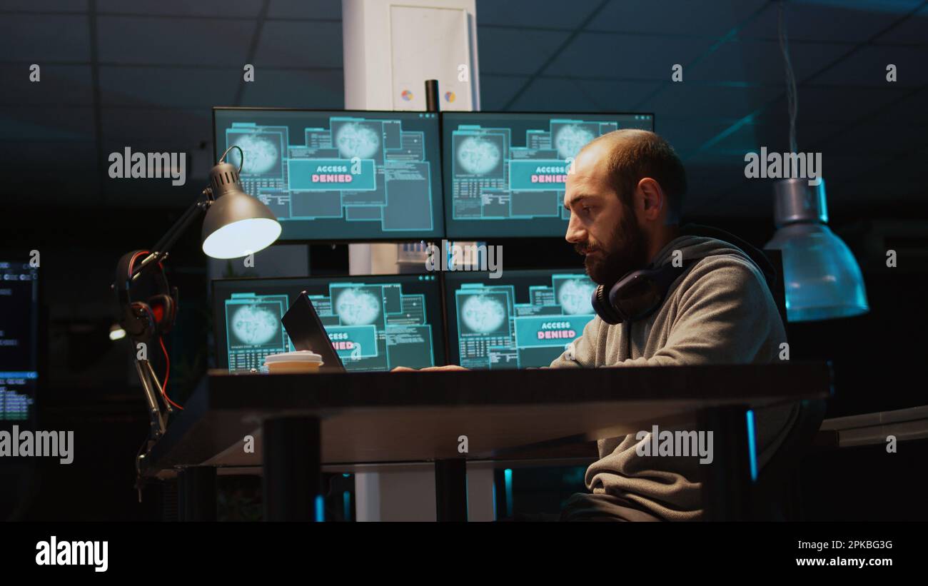 Aggressive violent hacker trying to hack network in office, feeling mad