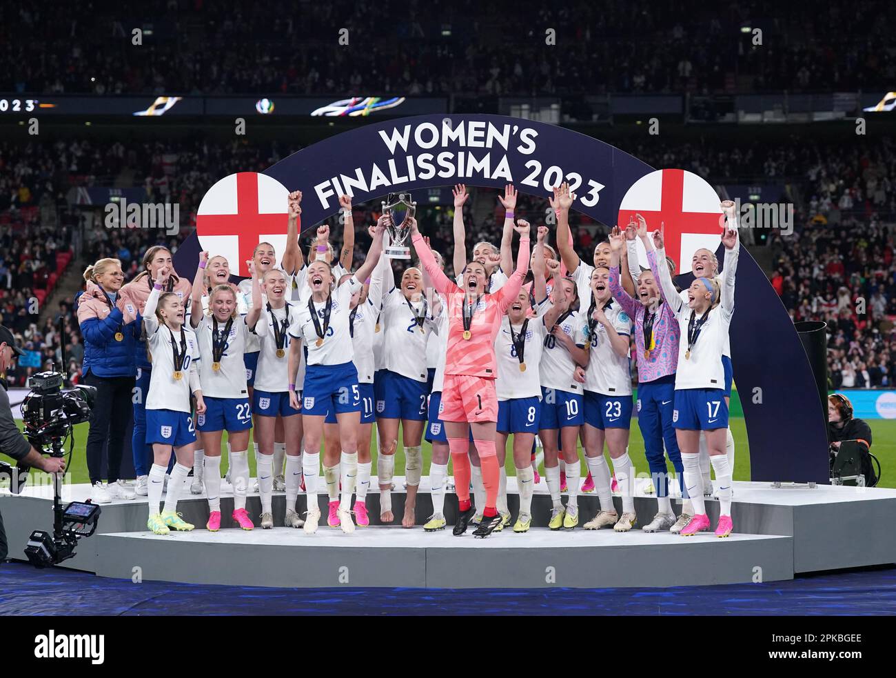 England players on the podium lift the trophy following the Women's