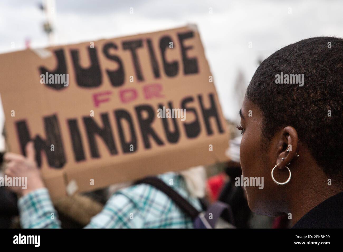 Windrush, UK. 06th Apr, 2023. A woman listens to speakers during the commemoration. Fifth anniversary of remembering those who have been impacted and exposing the Windrush scandal which saw people from the Caribbean treated like ‘illegal immigrants' by the Home Office despite arriving in Britain legally. Credit: SOPA Images Limited/Alamy Live News Stock Photo