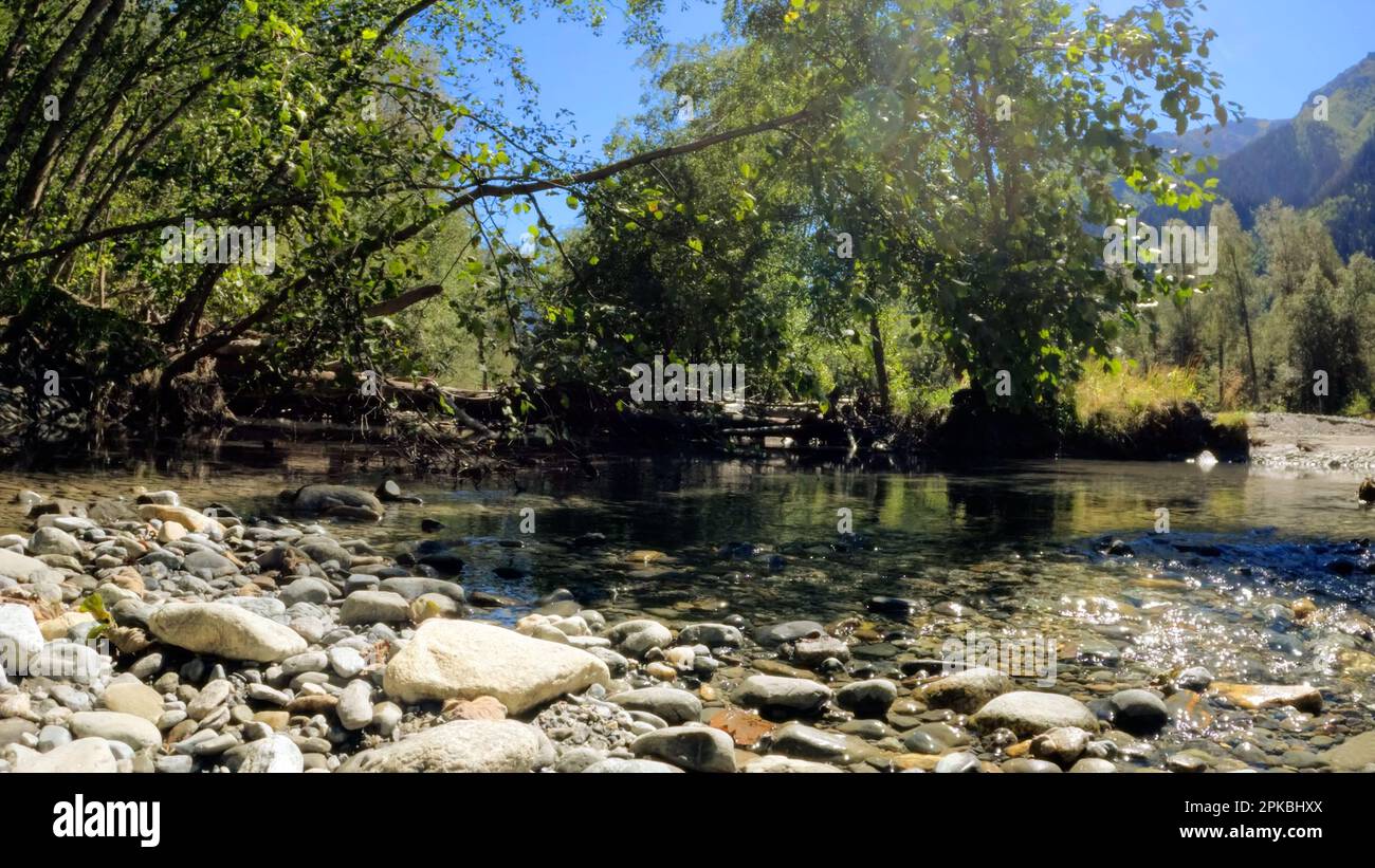 tiny clear cold stream with boulder rocks in Arkhyz mountain ridge ...