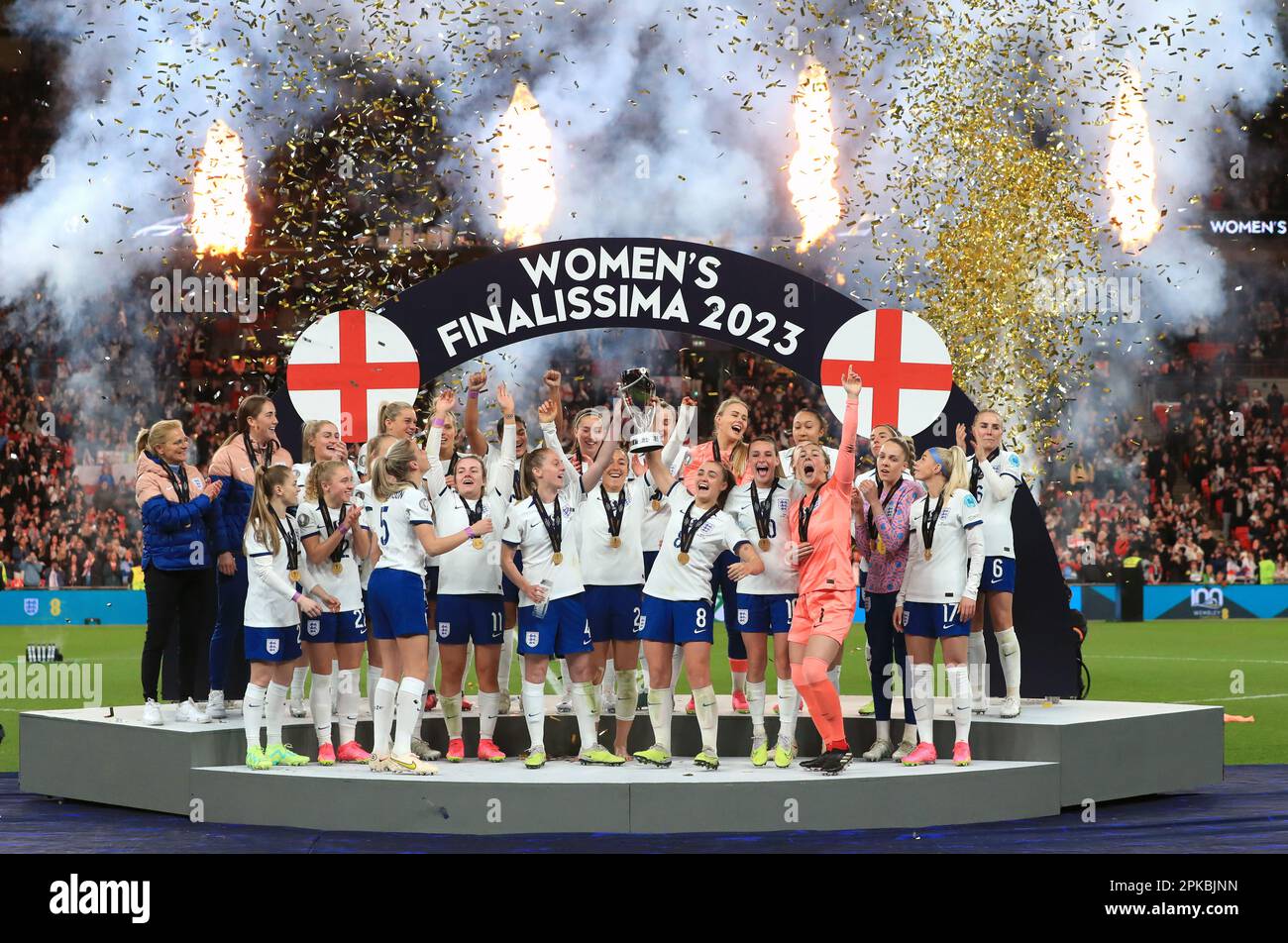 England players on the podium lift the trophy following the Women's