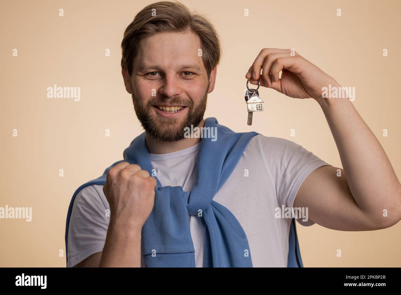 Happy caucasian man winner real estate agent lifting hand showing the