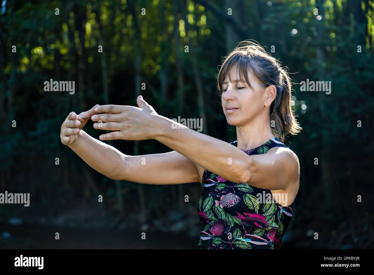 Qigong Female Master Practicing Chinese Martial Arts in Nature
