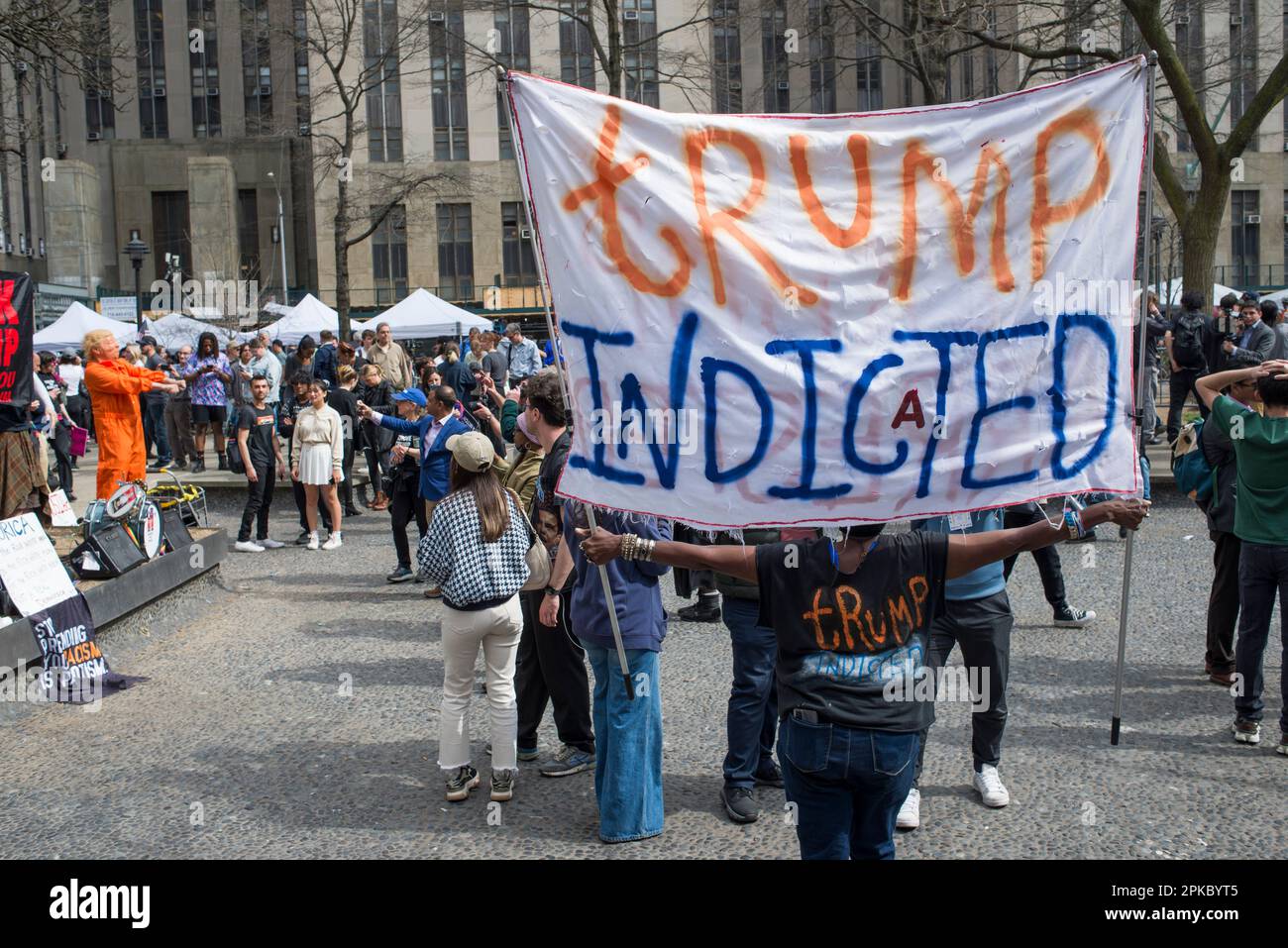 Anti-Trump supporter holds Trump indictment sign outside Manhattan Criminal Court House, NYC, during Trump arraignment on 04 April 2023. Stock Photo