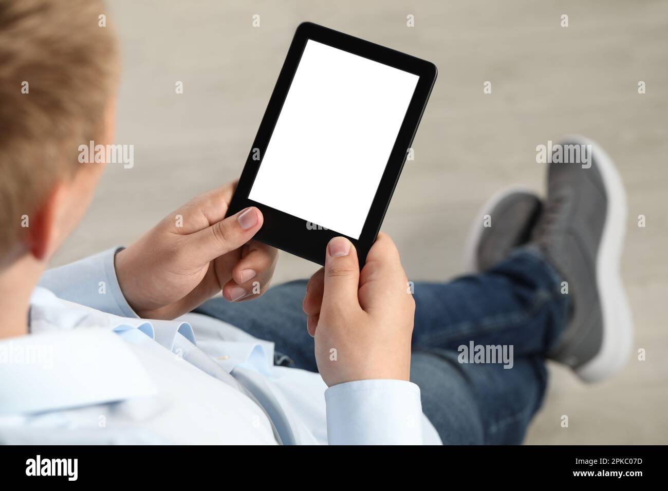 Man using e-book reader indoors, closeup view Stock Photo