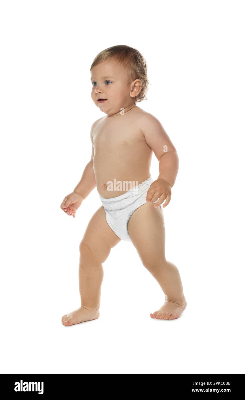 Cute baby in diaper learning to walk on white background Stock Photo