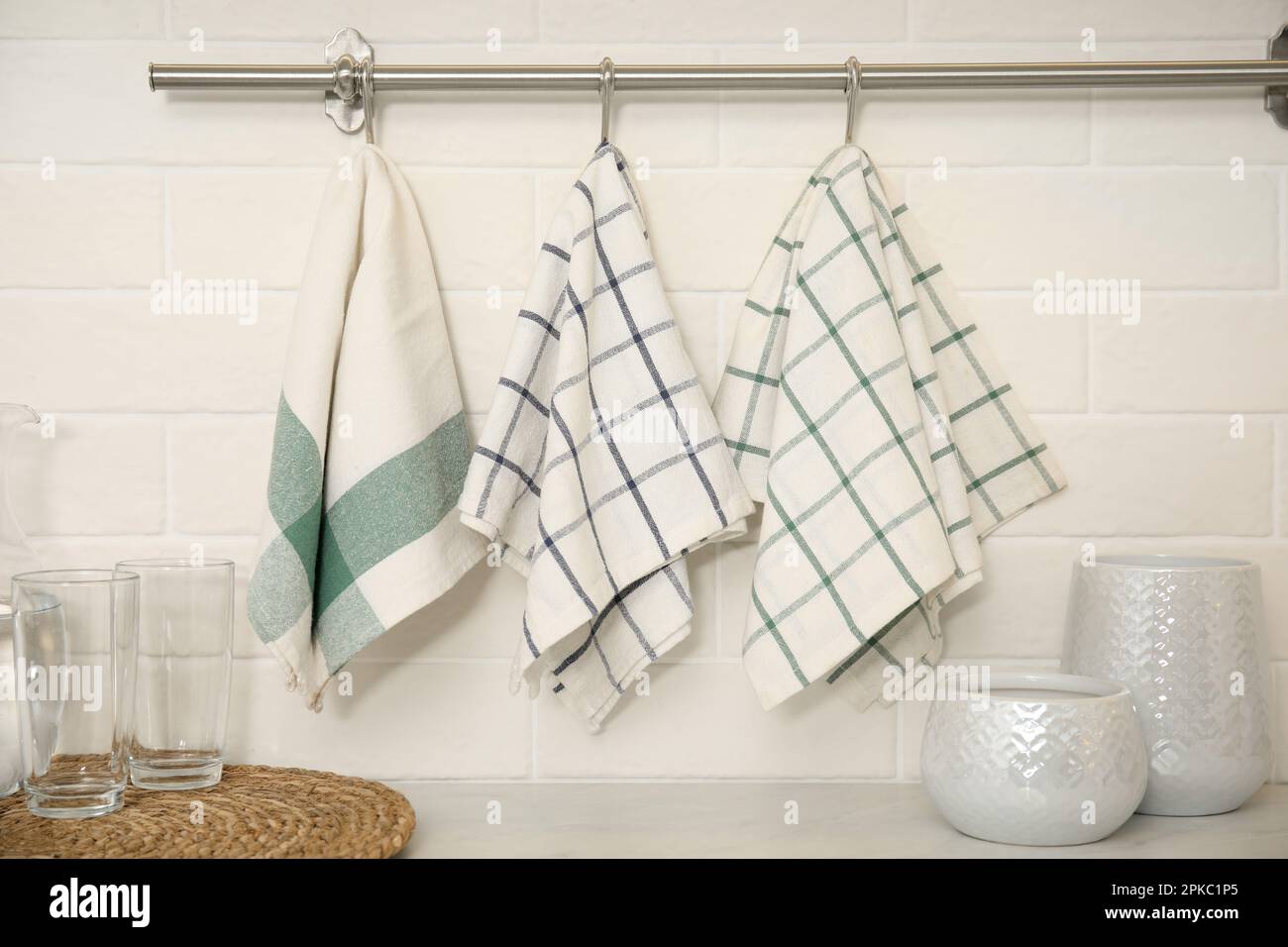 https://c8.alamy.com/comp/2PKC1P5/different-clean-towels-hanging-on-rack-in-kitchen-2PKC1P5.jpg