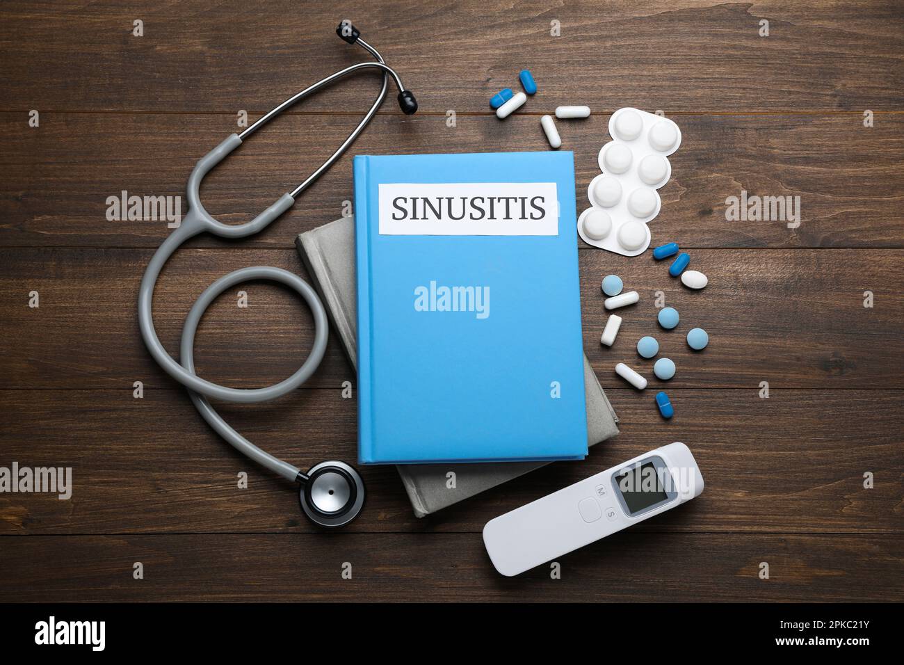 Books, pills and stethoscope on wooden table, top view Stock Photo - Alamy