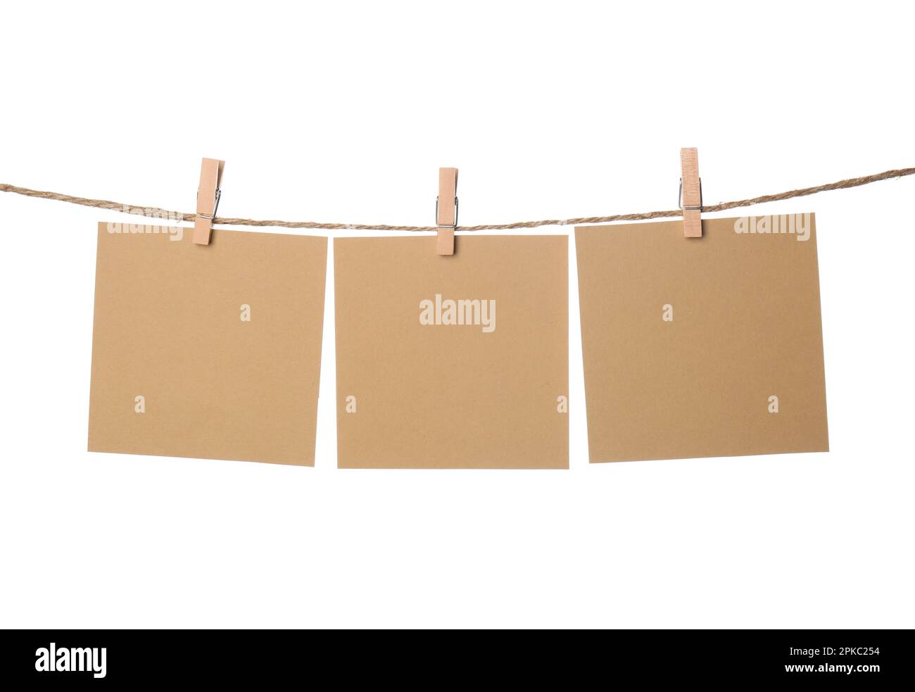 Clothespins with empty notepapers on string against white background. Space for text Stock Photo