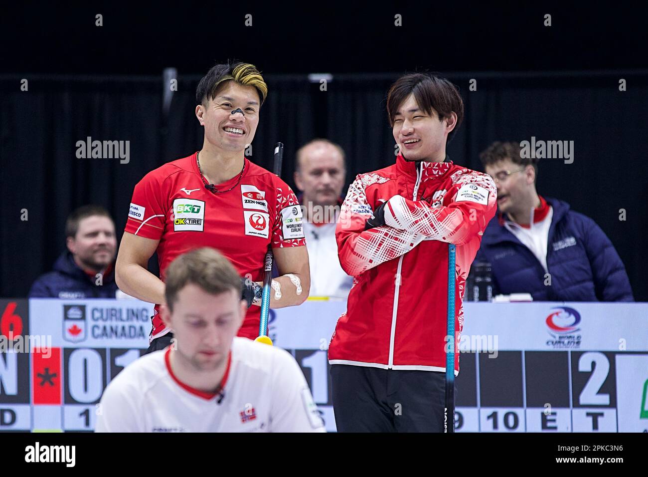 Tsuyoshi Yamaguchi and Riku Yanagisawa share a laugh during their game against Team Norway at the 2023 World Mens Curling Championship in Ottawa, Ontario, Canada on April 6, 2023