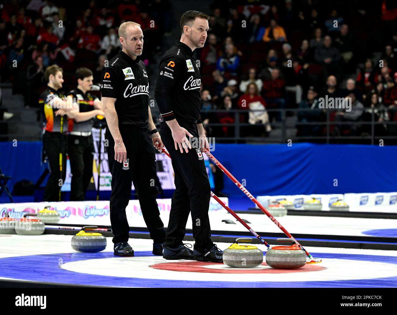 Canada skip Brad Gushue, right, and third Mark Nichols strategize
