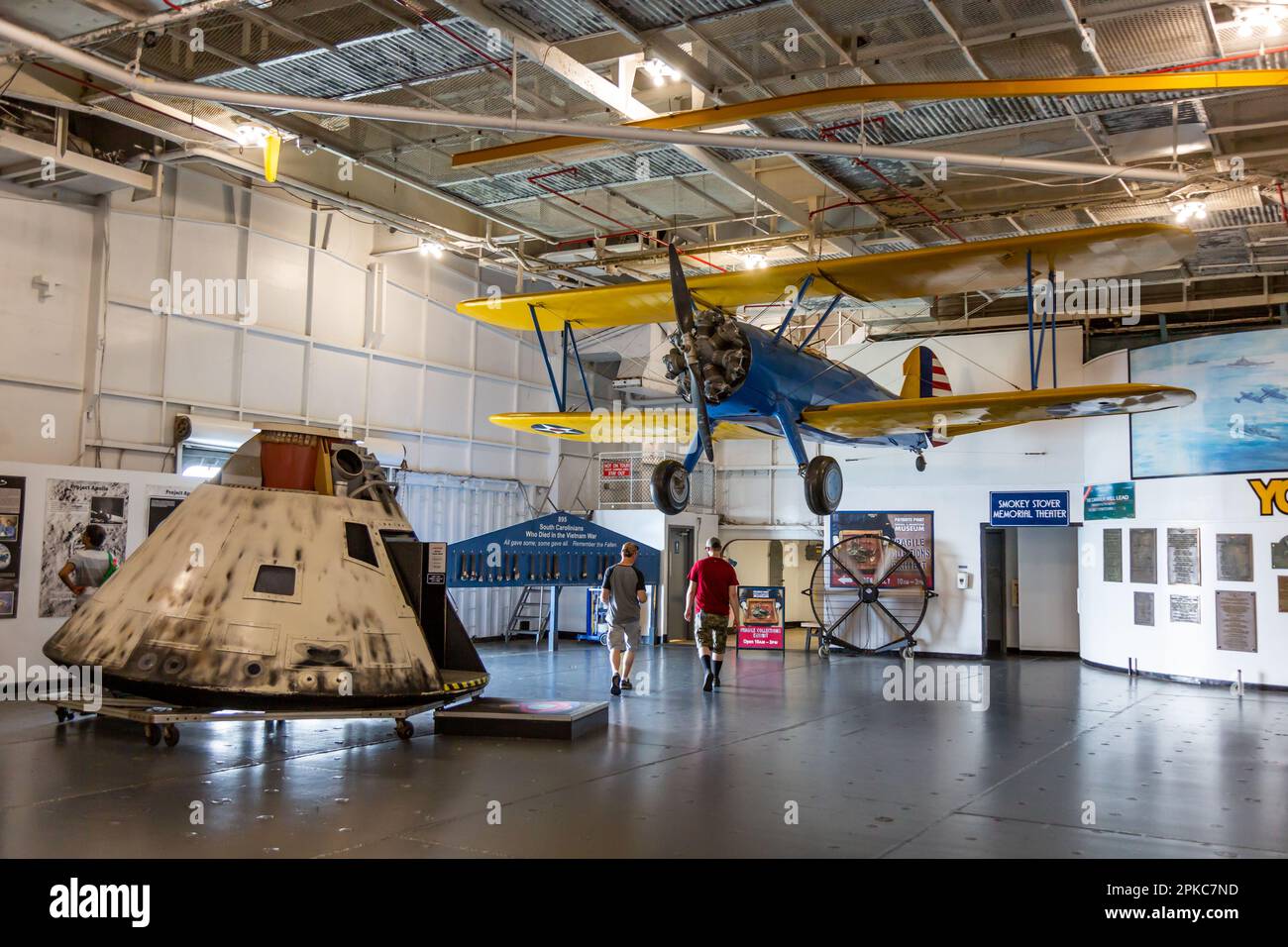 A replica of the Apollo 8 space capsule and a Boeing Stearman bi-plane on display aboard the USS Yorktown at Patriots Point Naval and Maritime Museum. Stock Photo