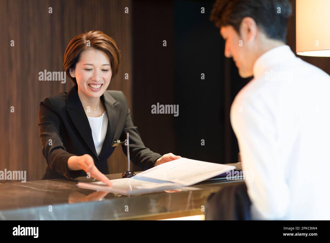Front desk staff dealing with customers Stock Photo Alamy