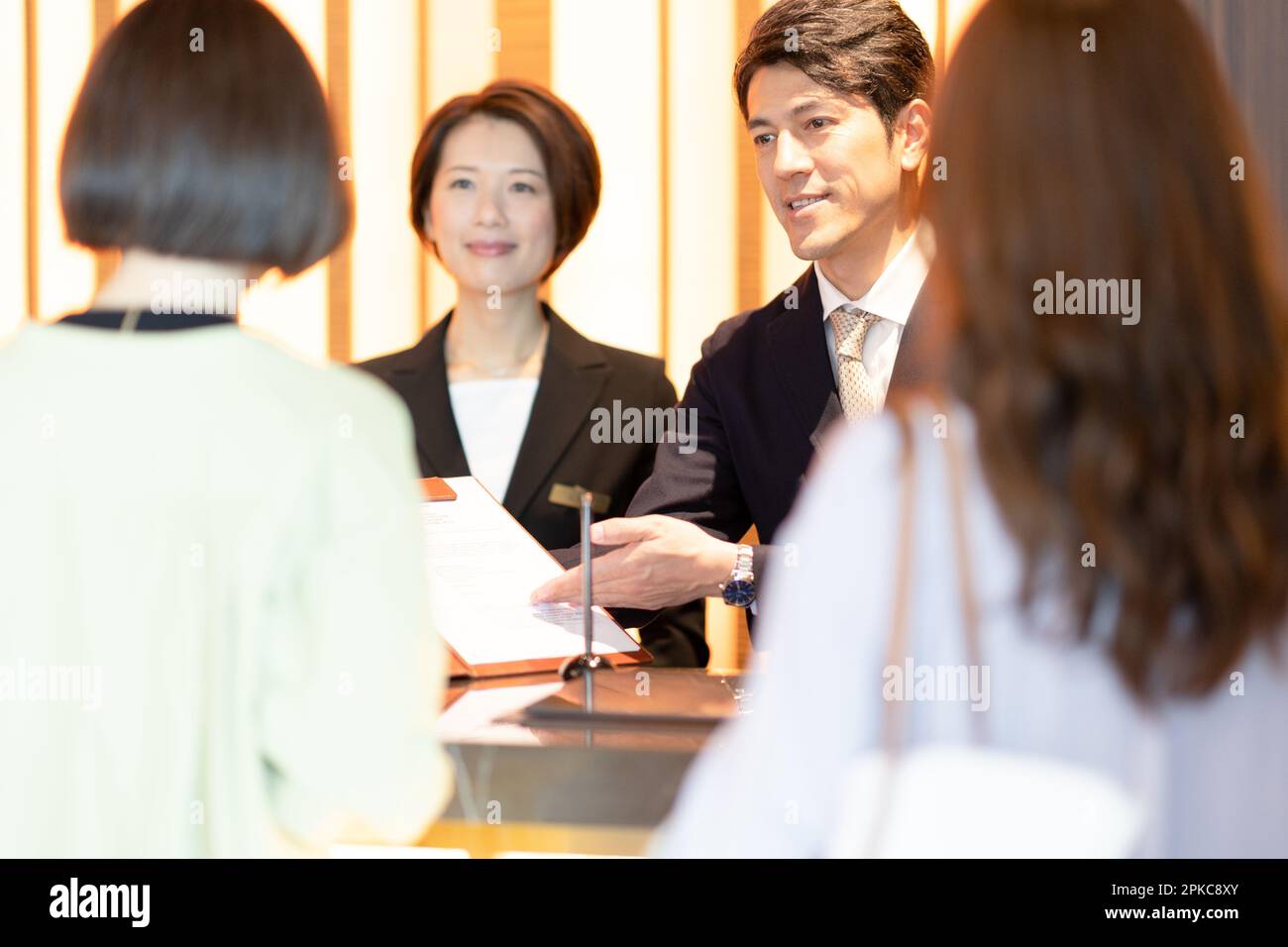 Front desk staff dealing with customers Stock Photo Alamy