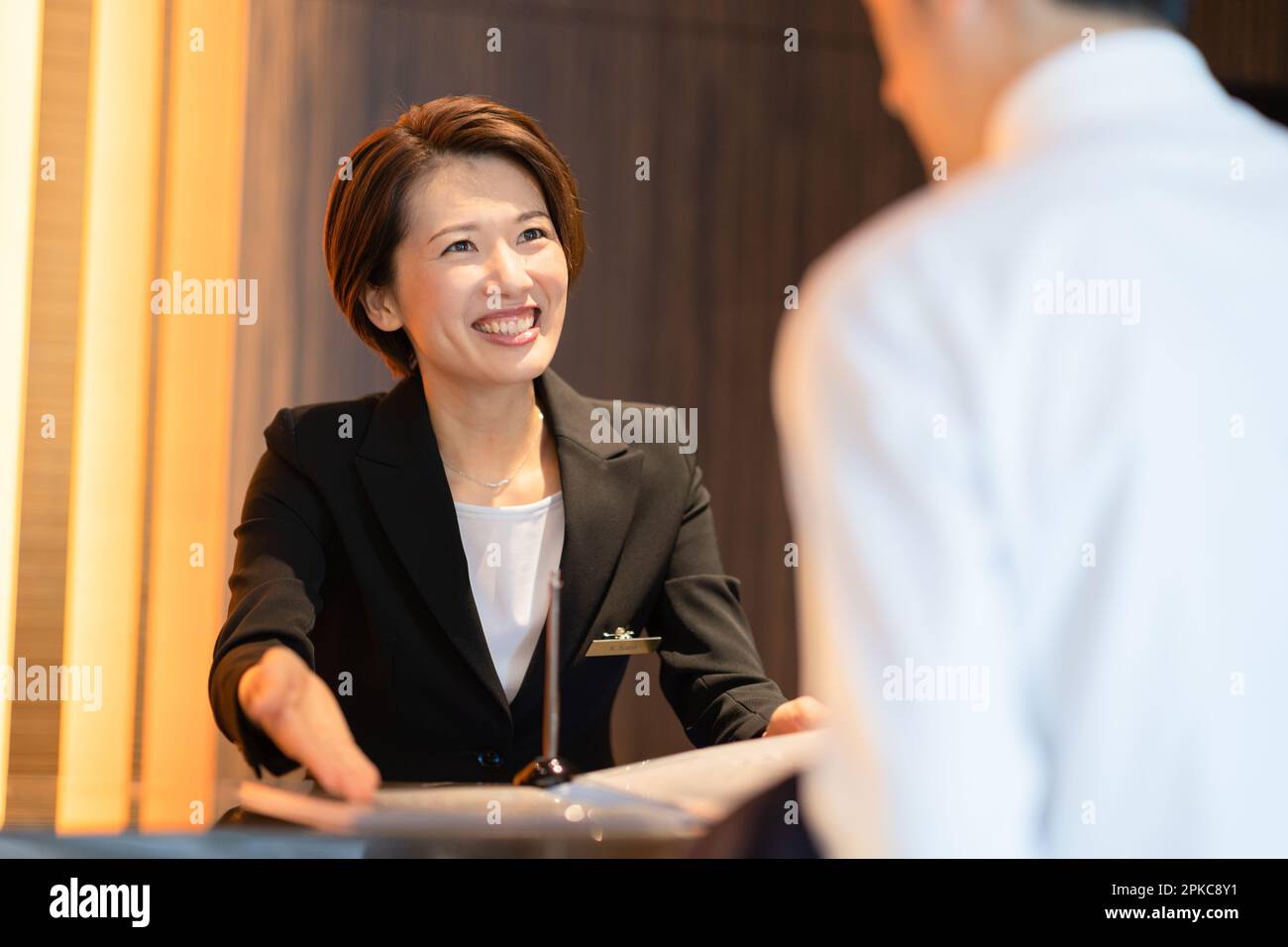 Front desk staff dealing with customers Stock Photo Alamy