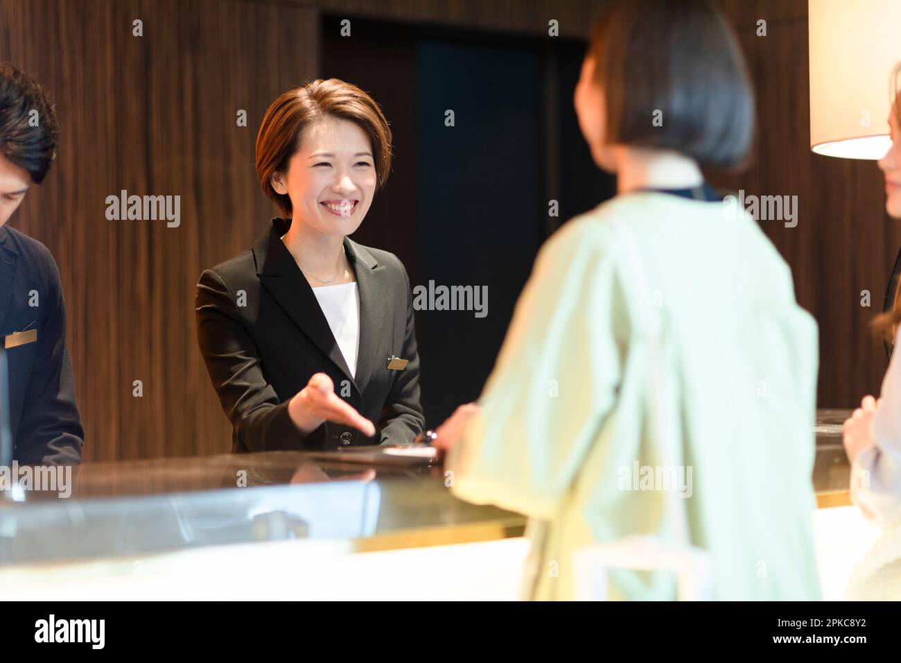 Front desk staff dealing with customers Stock Photo Alamy