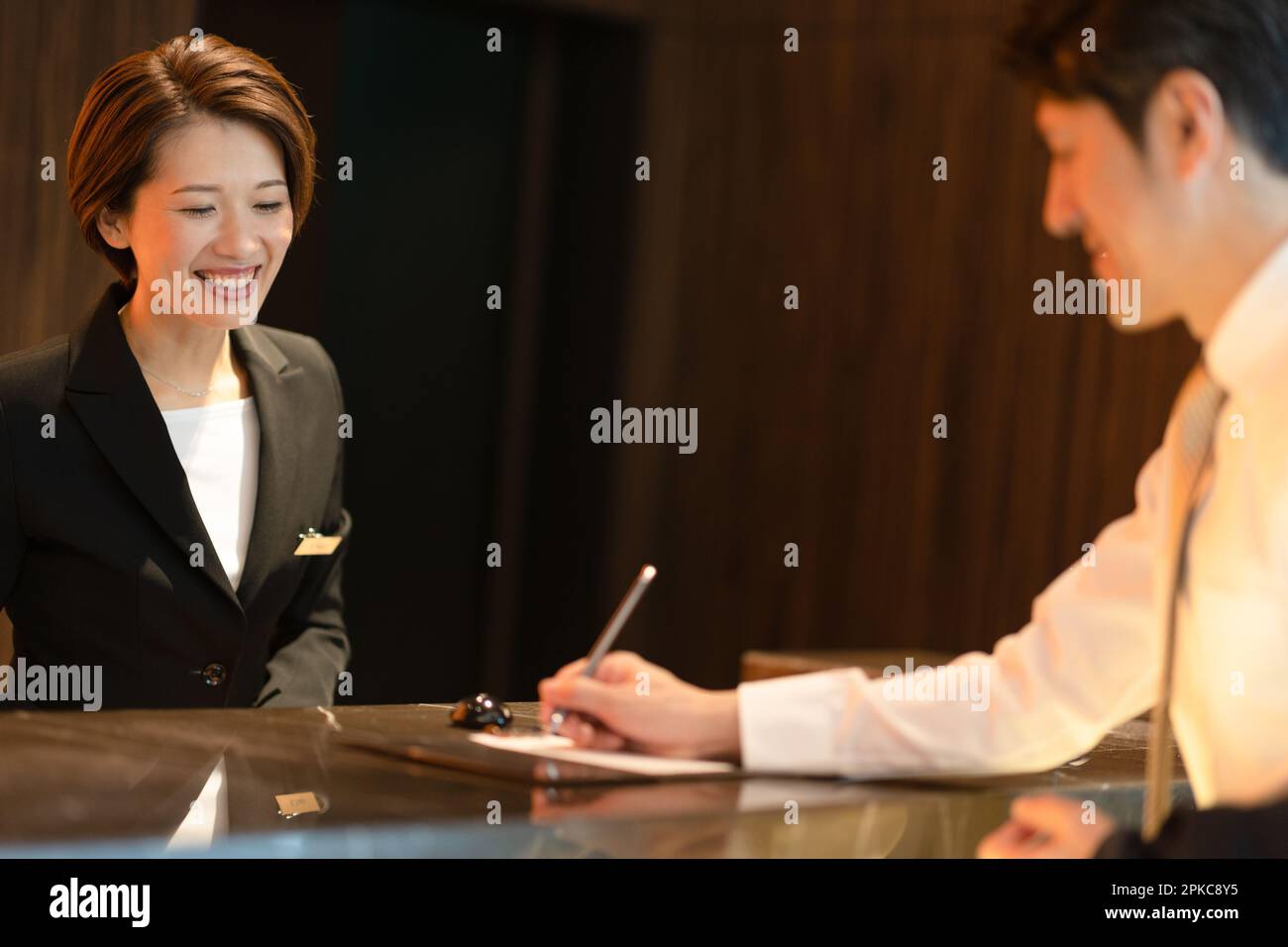 Front desk staff dealing with a customer Stock Photo Alamy