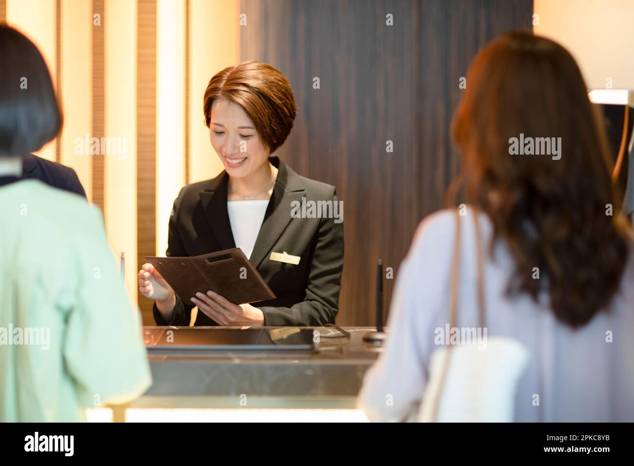 Front desk staff dealing with customers Stock Photo Alamy