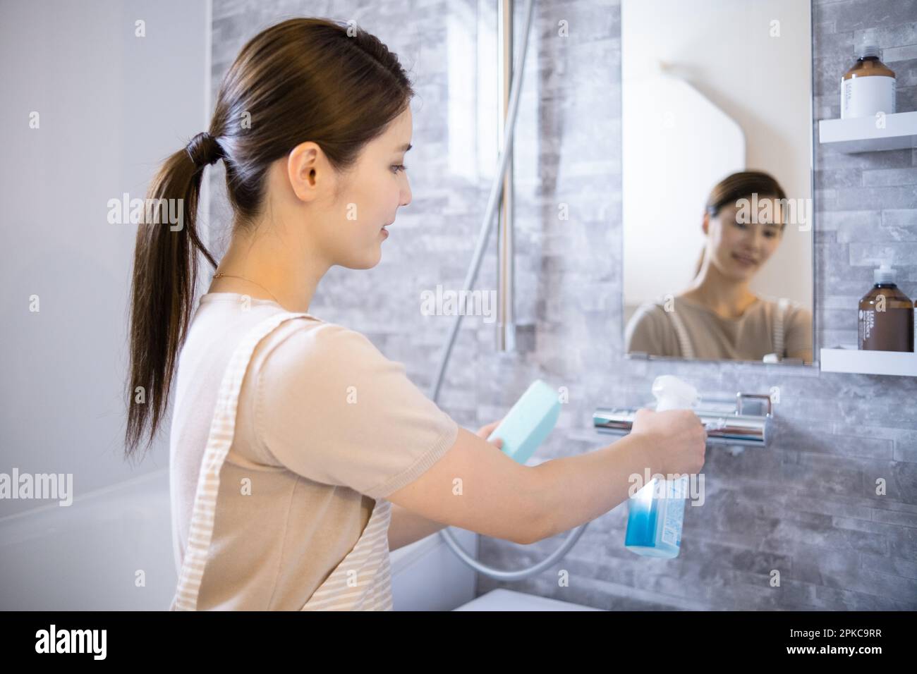Woman cleaning the bath Stock Photo