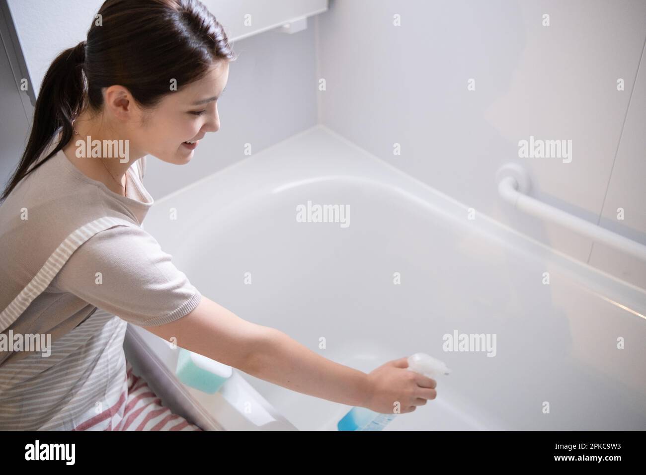 Woman Cleaning Bath Stock Photo