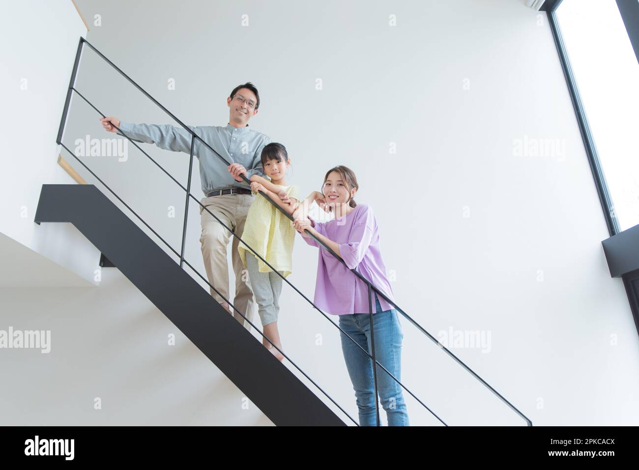 Parent and child standing on stairs Stock Photo