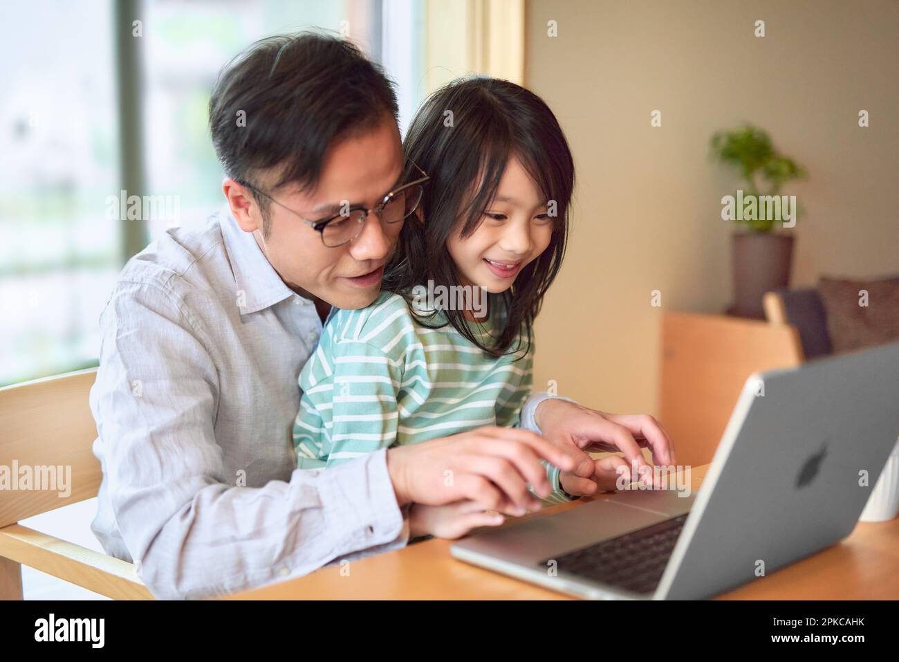 Parent and child operating a computer Stock Photo - Alamy