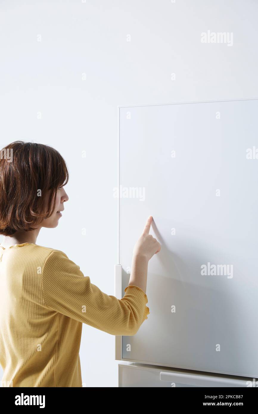 Woman touching a touchscreen refrigerator Stock Photo Alamy