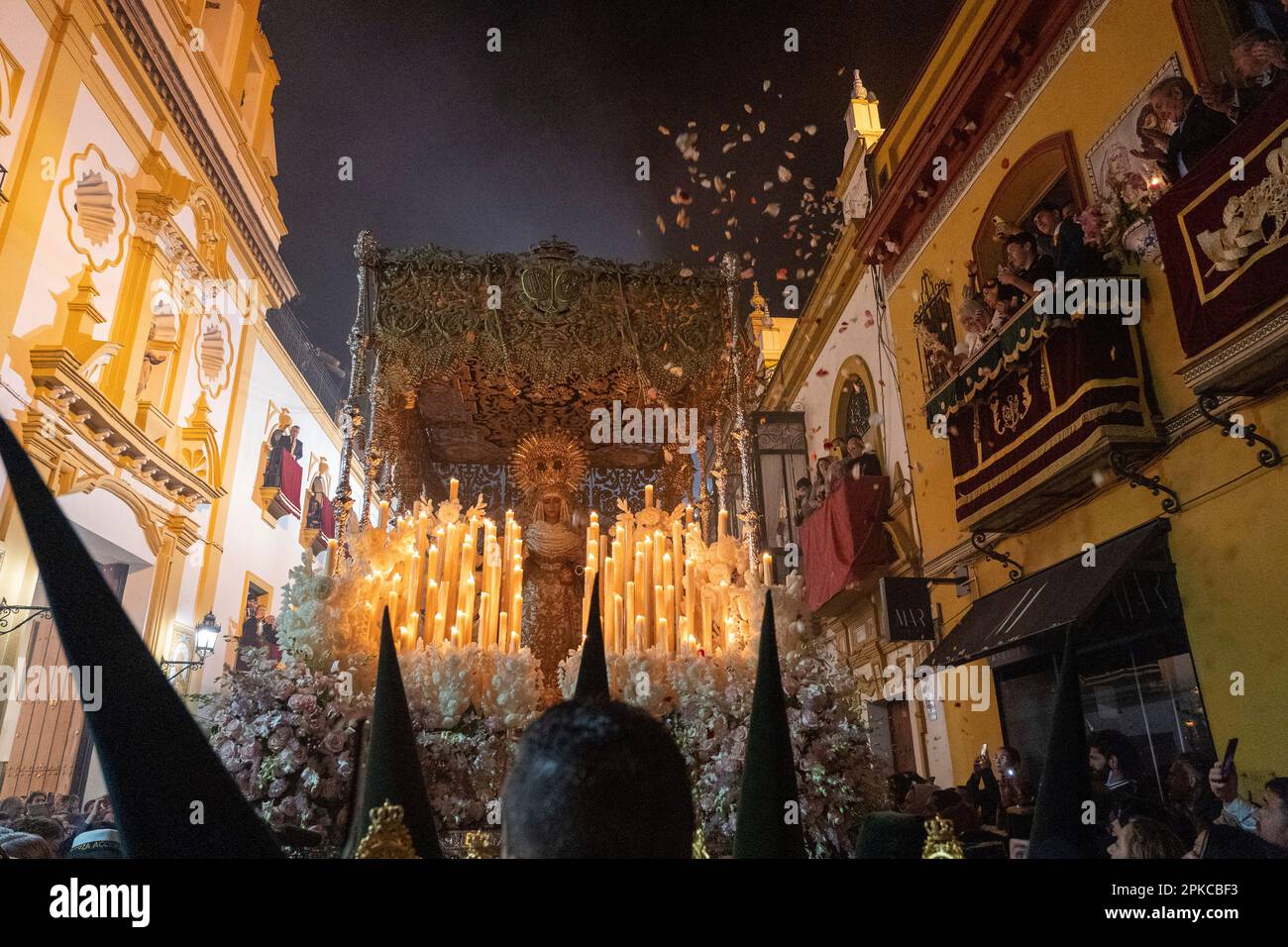 A shower of petals fall on La Virgen Esperanza de Triana after leaving ...