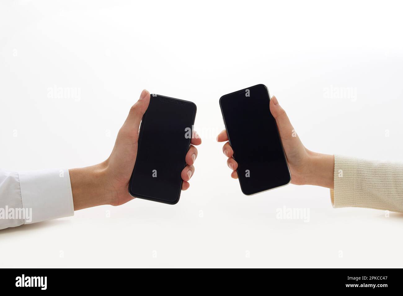 Two hands holding a new smartphone Stock Photo