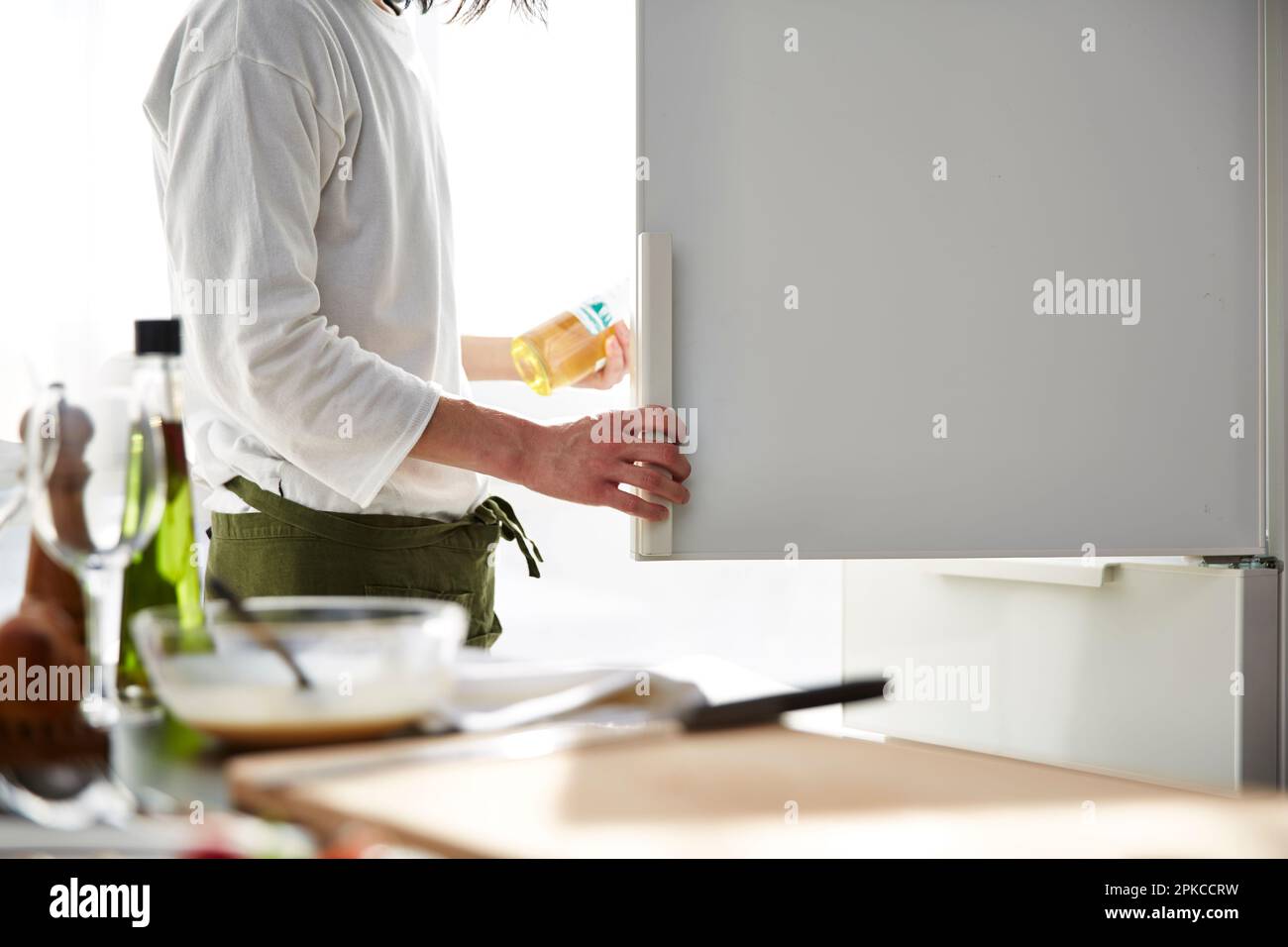Man taking wine out of refrigerator Stock Photo Alamy