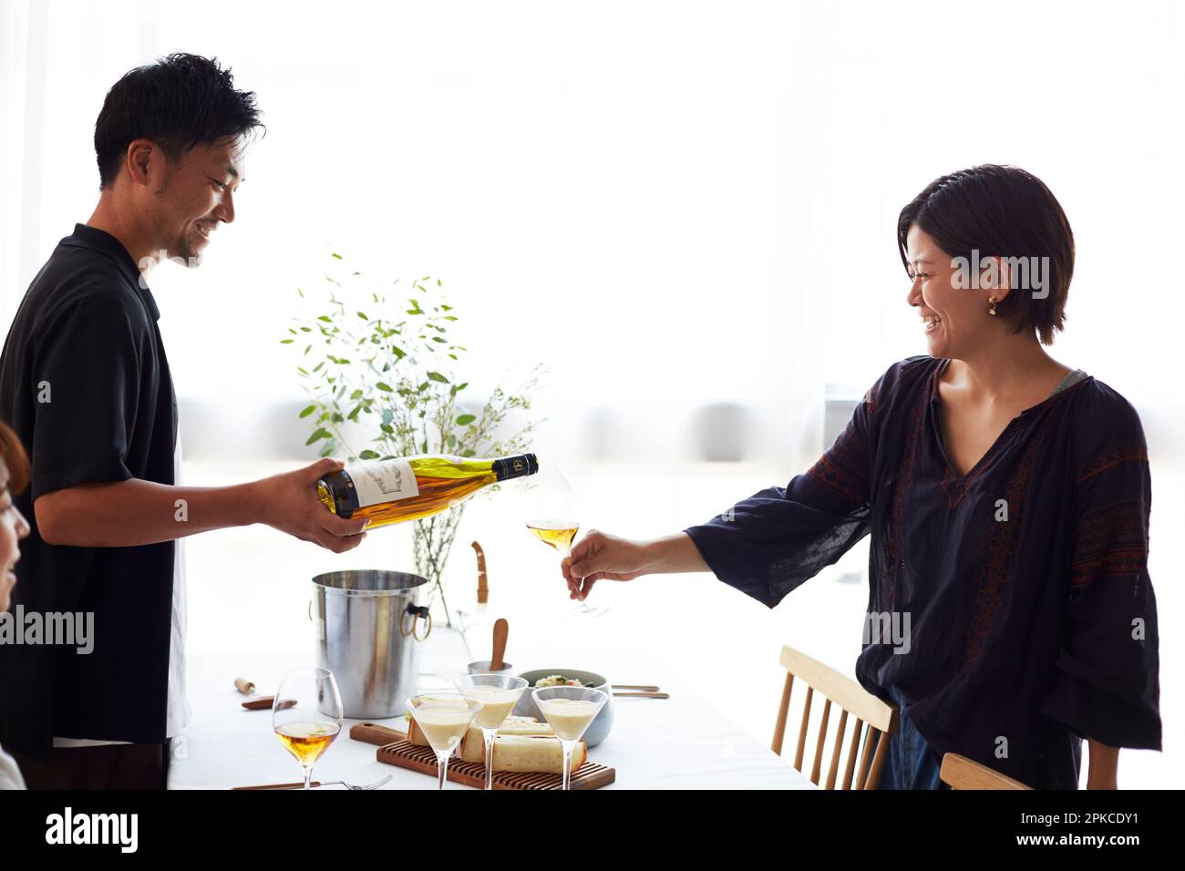 Man pouring wine for a woman Stock Photo