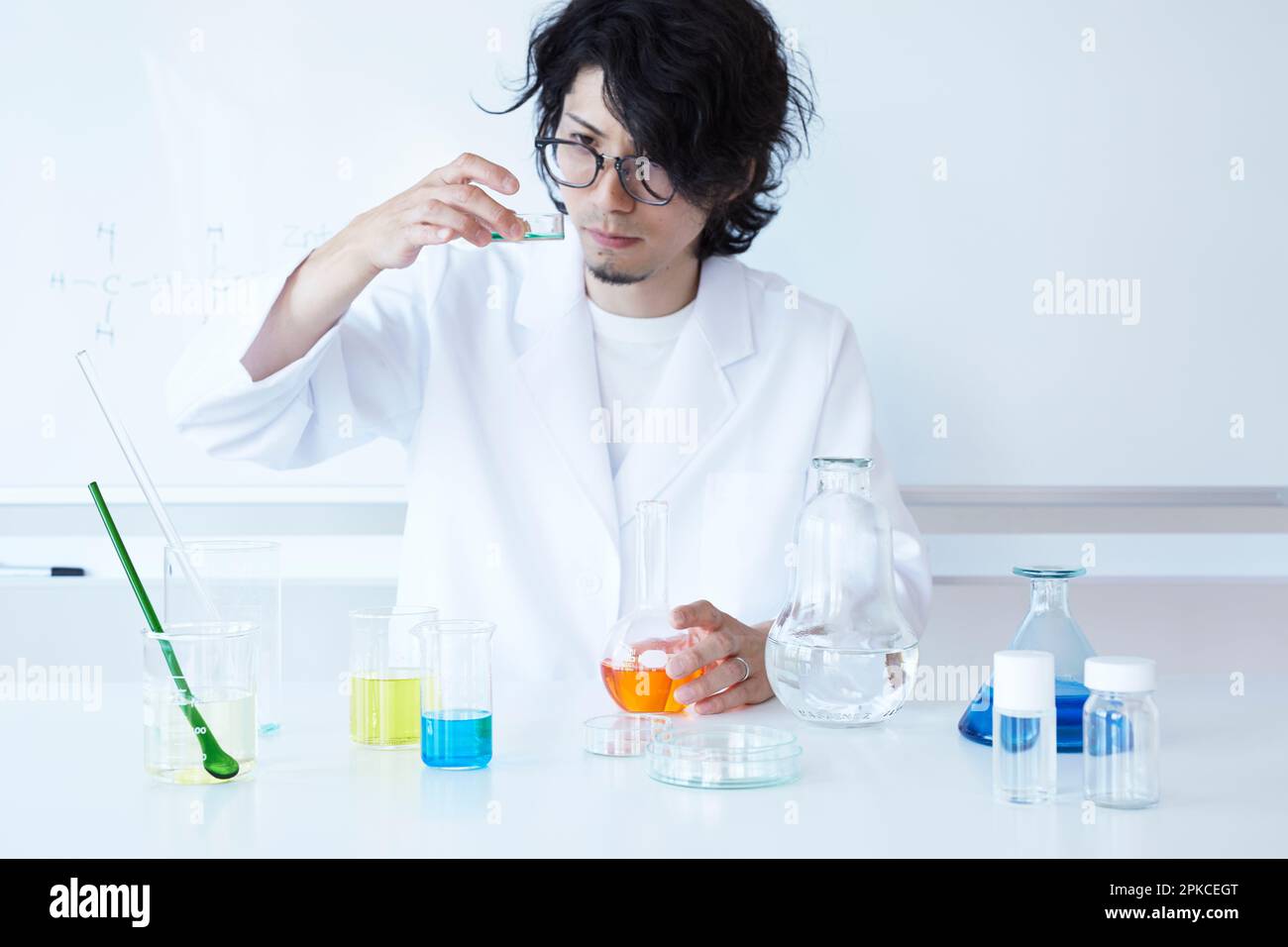 Man experimenting with colored liquid Stock Photo