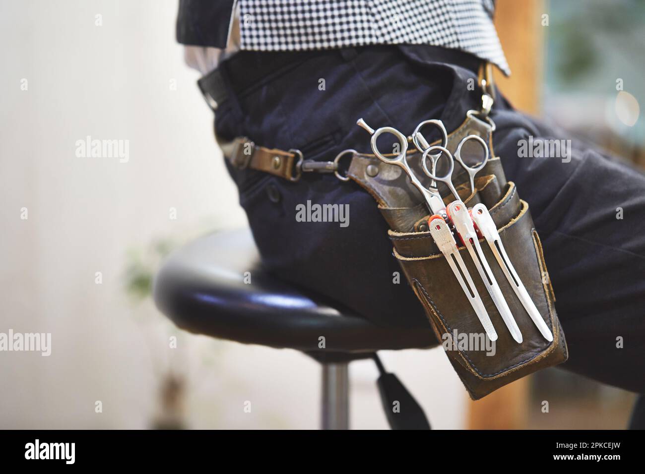 A close-up of a sitting hairdresser's waist bag Stock Photo