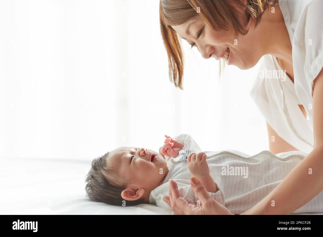 Baby and mother sleeping on white sheets Stock Photo Alamy
