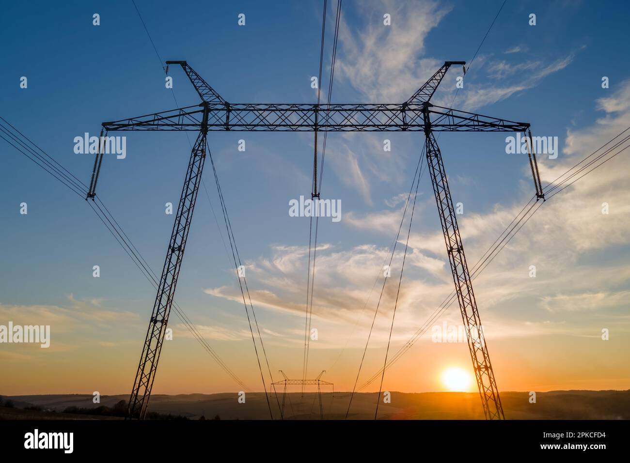 High voltage tower with electric power lines at sunset. Transmission of ...