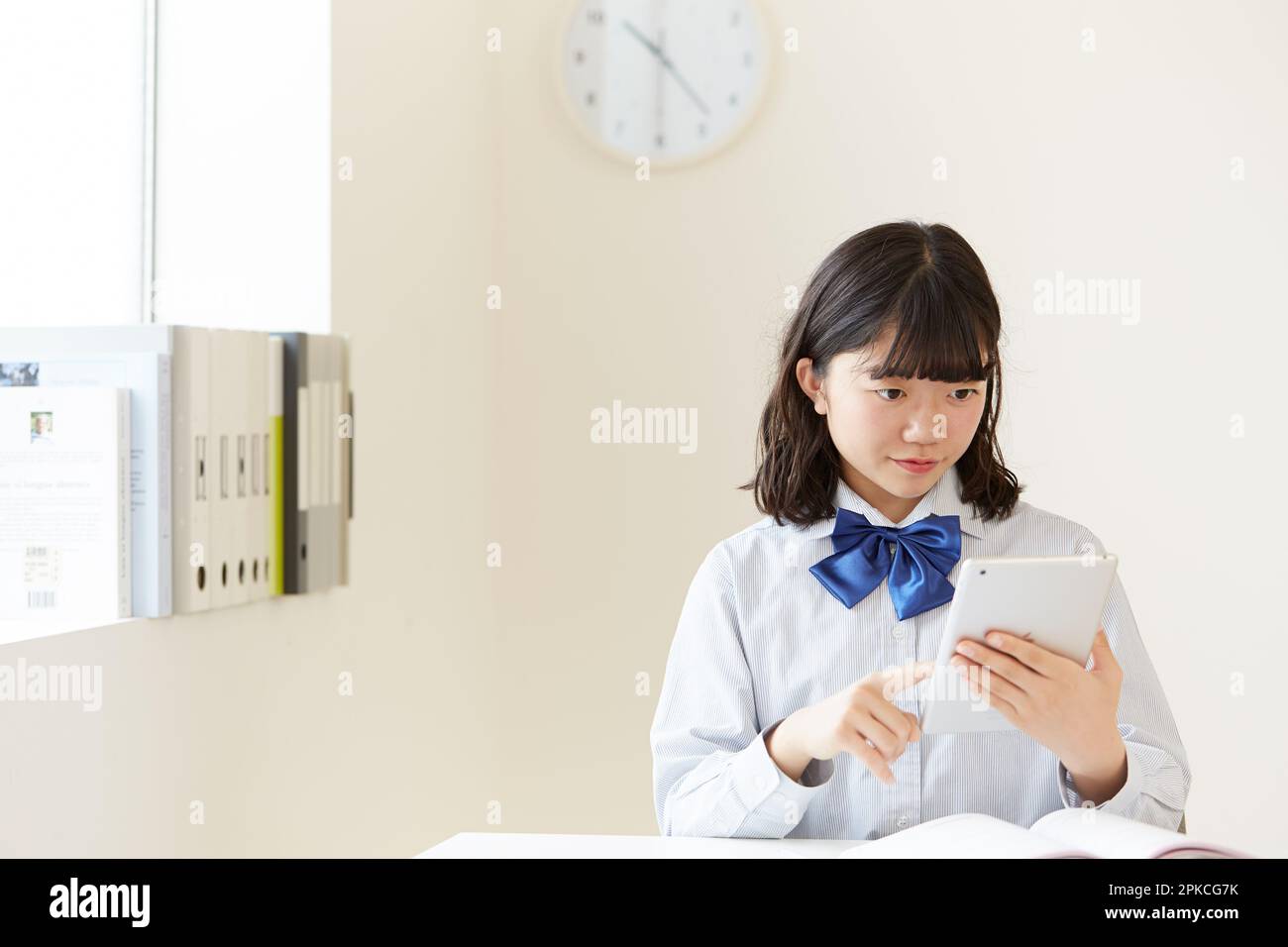 A high school girl studying using a tablet PC Stock Photo