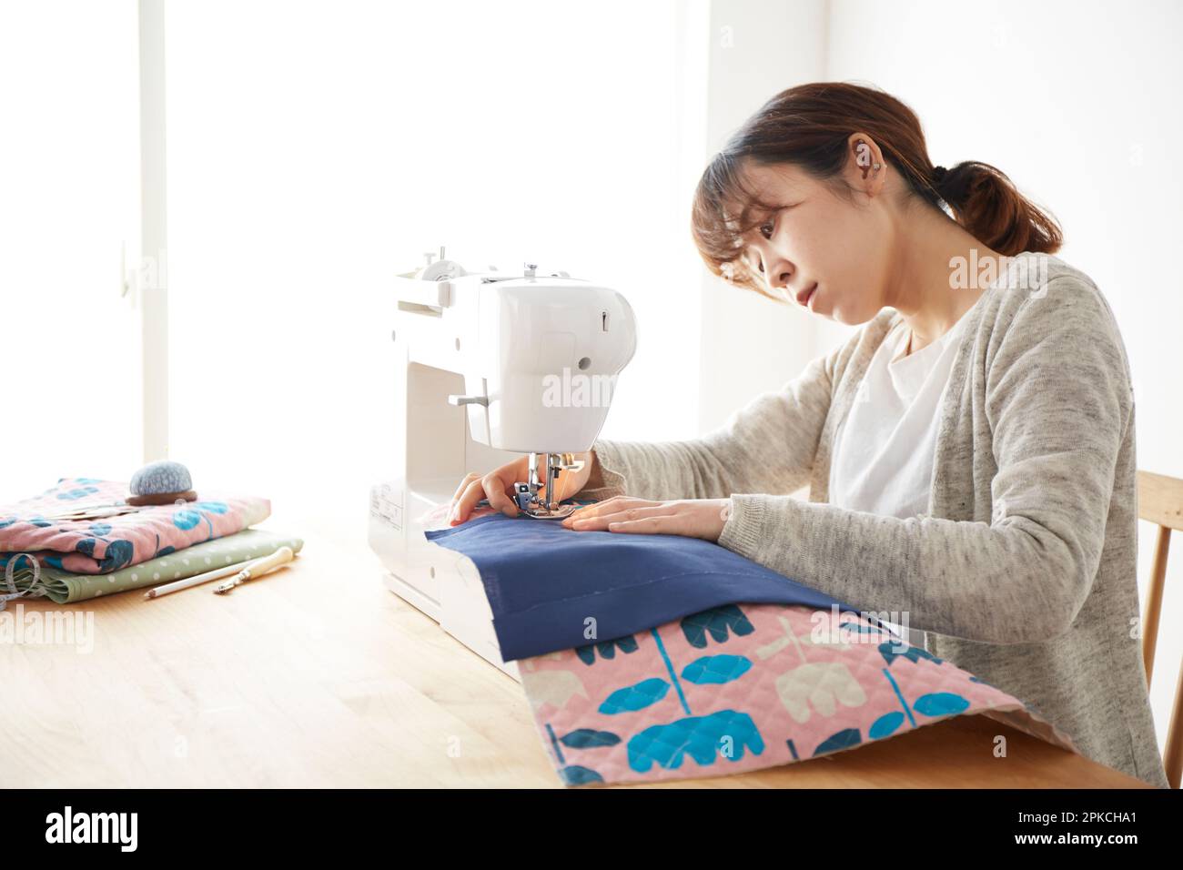 Woman sewing with a sewing machine Stock Photo Alamy
