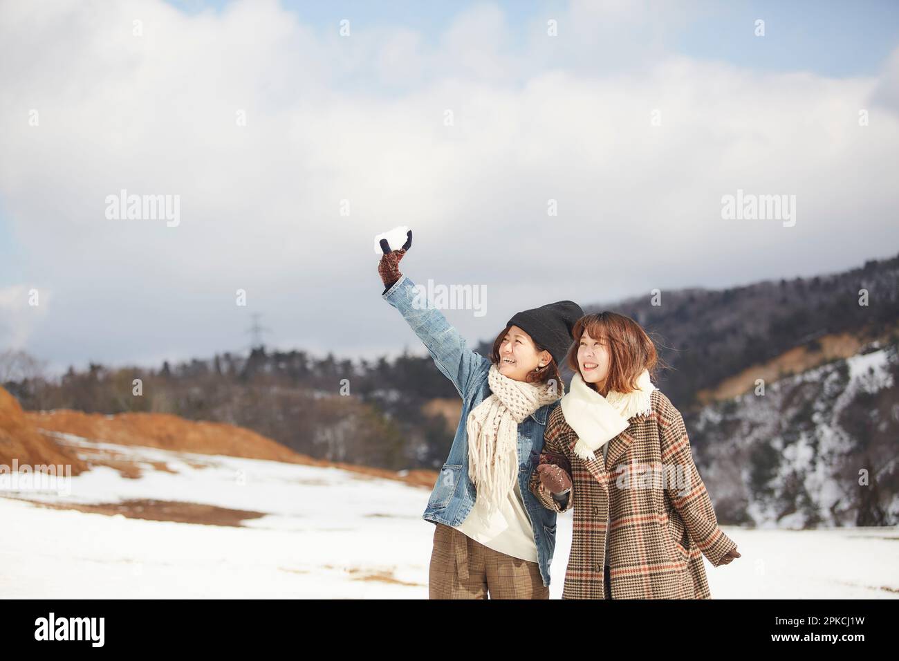 Two women playing in a snowy square Stock Photo